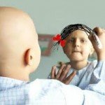 Young cancer patient sketching her hair on the mirror 
